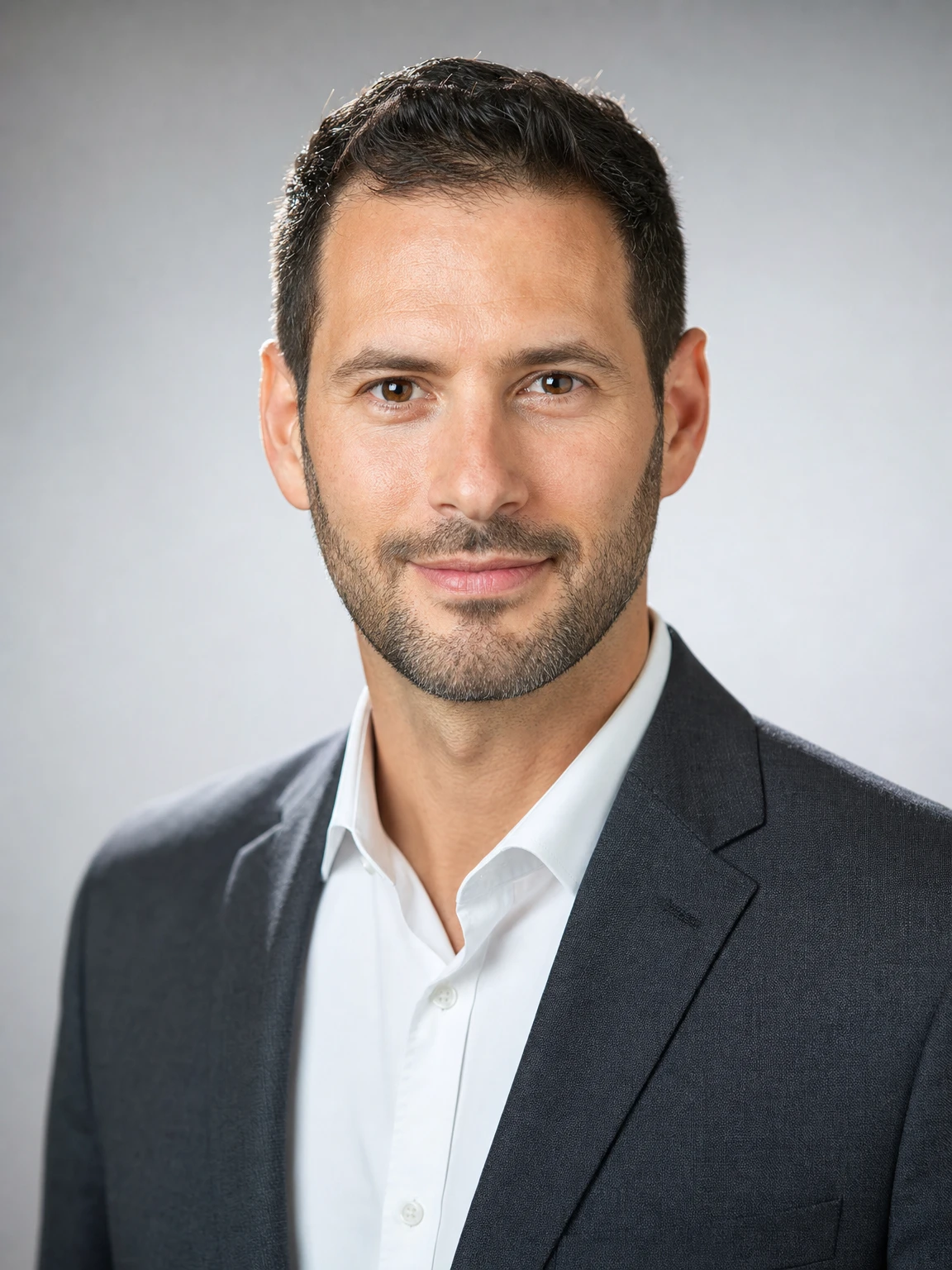 business headshot of a man in a charcoal suit